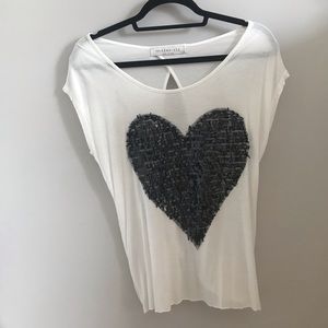 the clas-sic white tee shirt and black heart